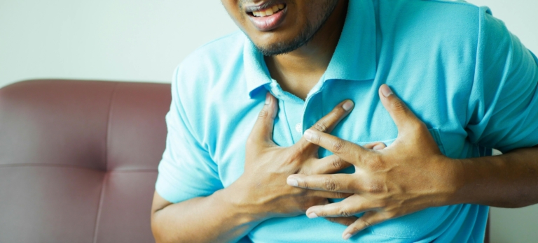 Close-up of a Man in Blue Polo Shirt with Hands on Chest