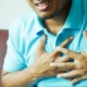 Close-up of a Man in Blue Polo Shirt with Hands on Chest