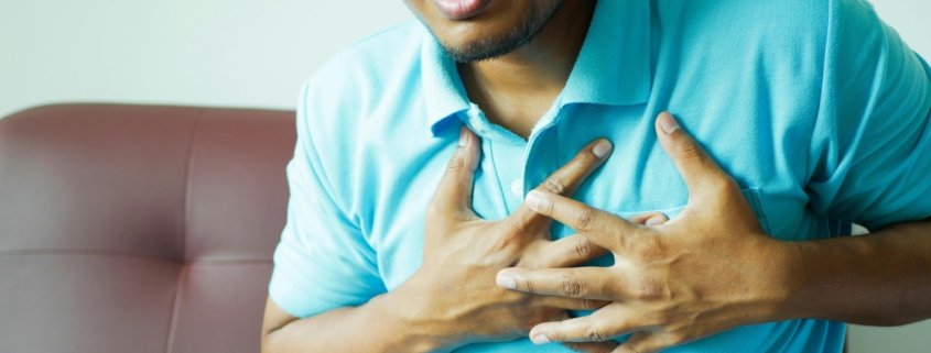 Close-up of a Man in Blue Polo Shirt with Hands on Chest