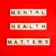 Mental Health Matters Spelled on Letter Tiles on Red Background