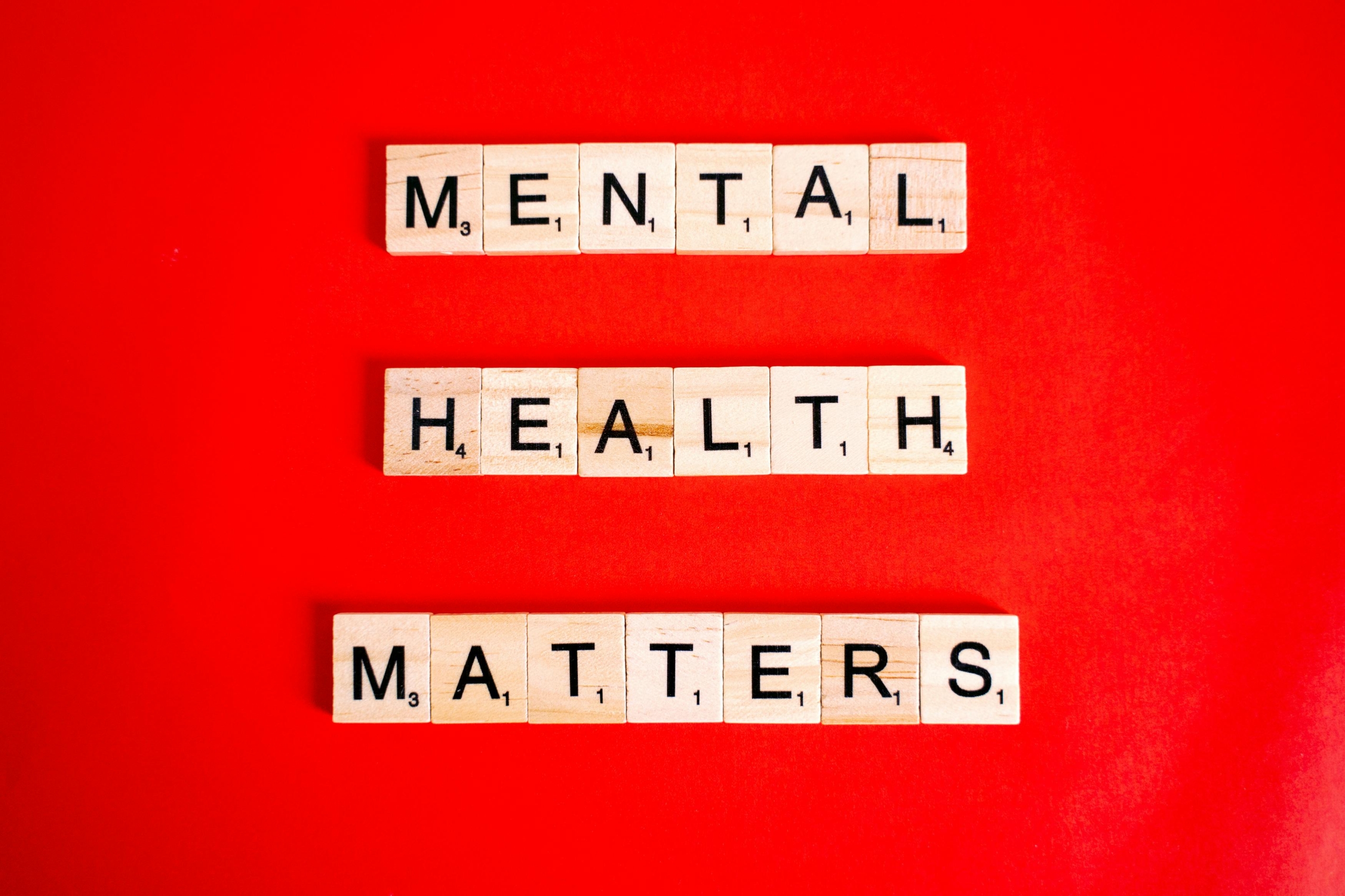 Mental Health Matters Spelled on Letter Tiles on Red Background